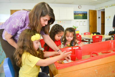 teacher helping her students